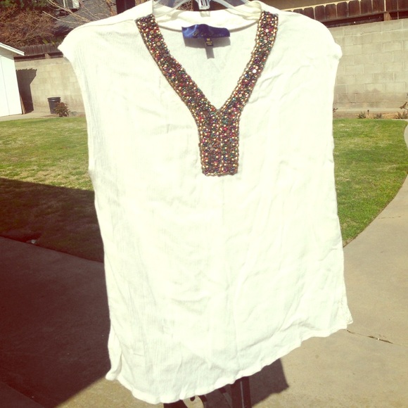 Off white sleeveless top in medium.