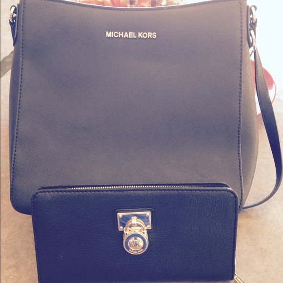 Black MK large wallet with black MK crossbody bag.
