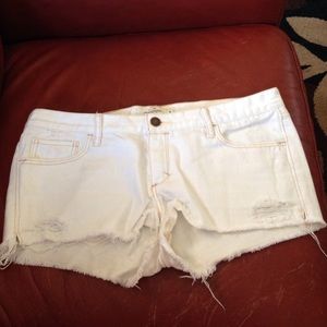 Distressed white jean shorts