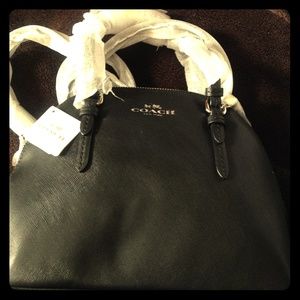 I'm selling a brand new Coach mini satchel purse.