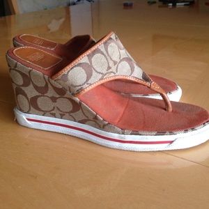 Brown coach logo wedge flip flops