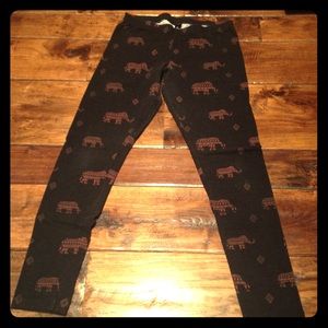 Black leggings with copper colored elephants.