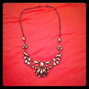 Dark colored necklace.
