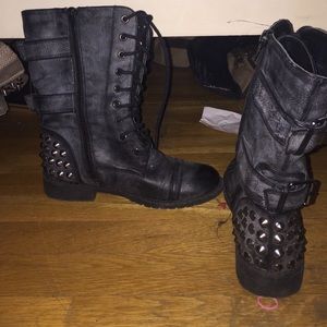 Faded black combat boots with spikes