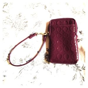 Coach phone wristlet holder with card slots.