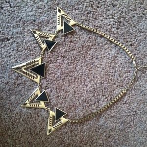 A gold and black necklace