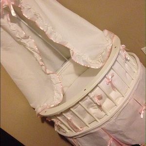 White and pink bassinet