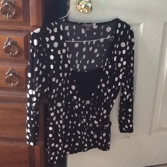 Back with white polka dots shirt.