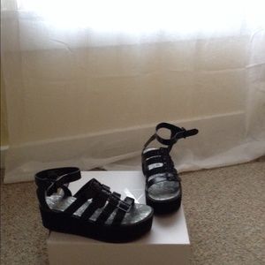 Platform sandals with ankle straps.