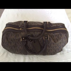 Medium sized Michael Kors carry on.