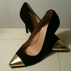 Black suede pump with flat gold point toe