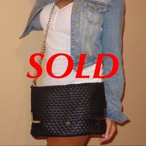Black woven fold-over cross body bag