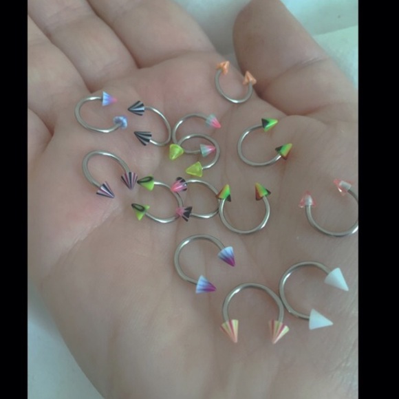 THREE septum / ear / nose rings.