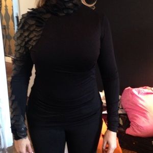 Black turtle neck. Leather and tule detail