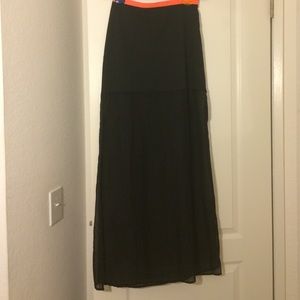 Long black skirt with a pink-orange band Long black skirt with a pink-orange band