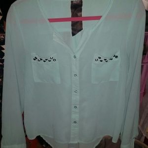 Mint green top with studs on the pockets