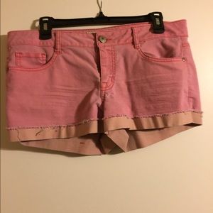 Pink short shorts with a tangerine hem.