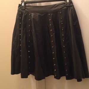 Black leatherette pleated skirt with gold studs