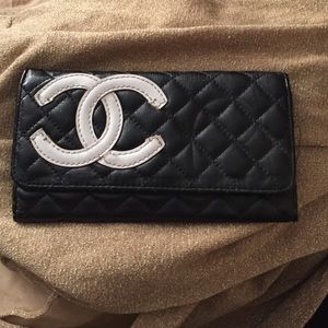 Black leather quilted wallet with white emblem