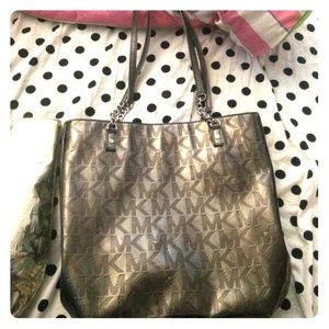 Grey metallic Michael Kors bag.