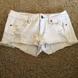 White ripped shorts