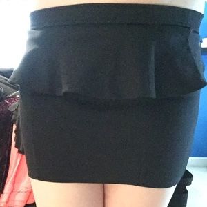 Short black peplum skirt