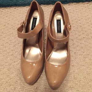 Dark nude Mary Jane pumps.