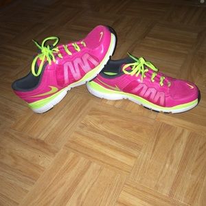 Pink and neon yellow Nike tennis shoes