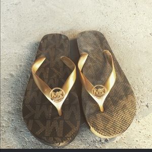 Michael Kors brown and gold flip flops