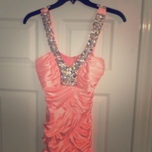 Long light orange prom dress.