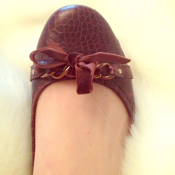 Chocolate leather flats with velvet bows on toes