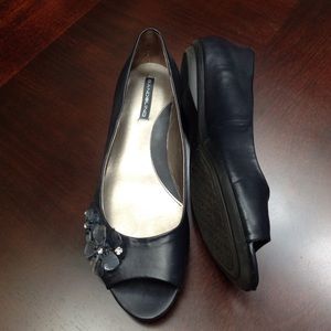 Open toe Navy flats with flower on side.