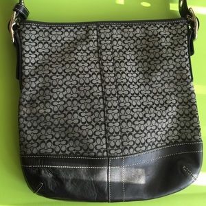 Coach bag with long shoulder strap.