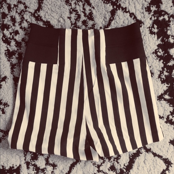 High-waisted black and white striped shorts.