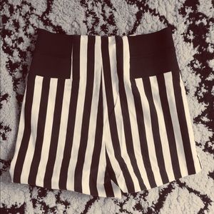 High-waisted black and white striped shorts.