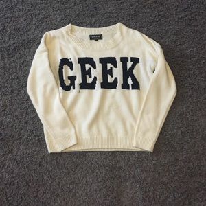 A larger sweater that says geek