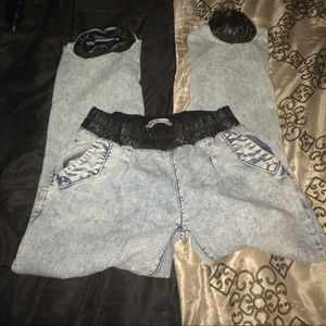 Denim pants with leather cuffs on bottom of pants