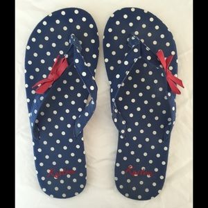 Blue/white polka dot flip flops with red bow.