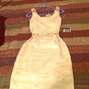 Short, gold lace dress with jeweled belt and strap