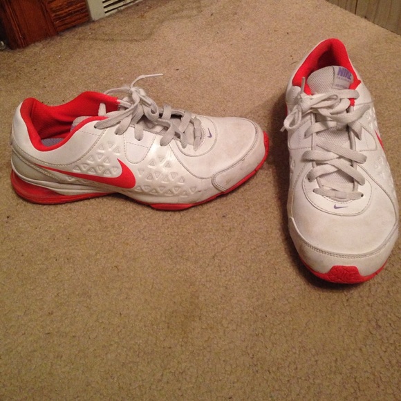 White and orange NIKE tennis shoes