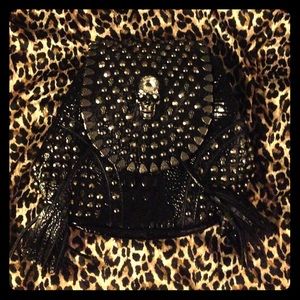 faux croc backpack with skull stud embellishment.