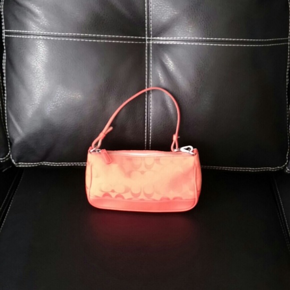 Used bright orange Coach purse
