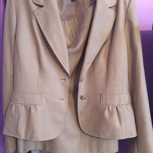 A light brown two piece skirt suit