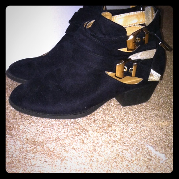 Black booties with gold colored buckels.