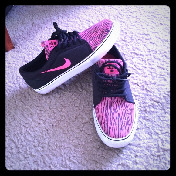 Pink and black zebra striped nikes.