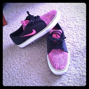 Pink and black zebra striped nikes.