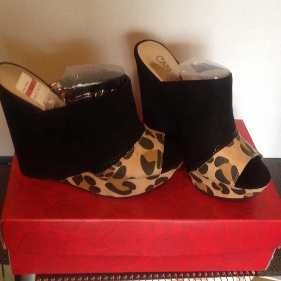 Cheetah print and black wedges .
