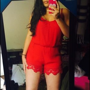 Red romper with lace detail on the bottom