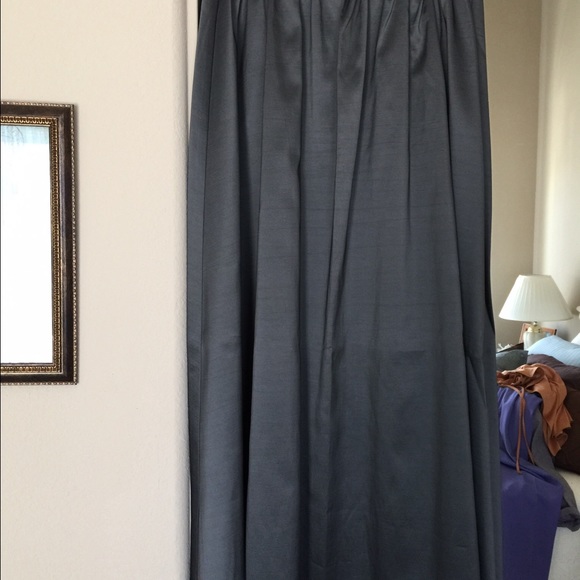 Floor length dark grey skirt.