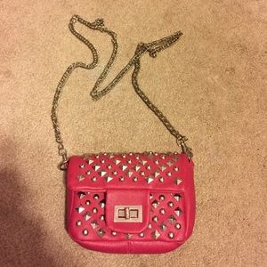 Studded pink satchel w/ a silver chain strap